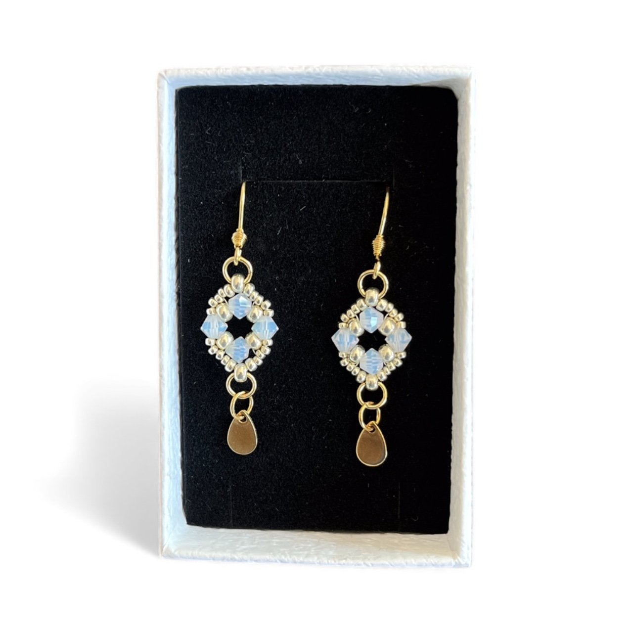 69128a9eaba6d113bfcf572d_beaded-drop-with-charm_1764285178032.jpeg