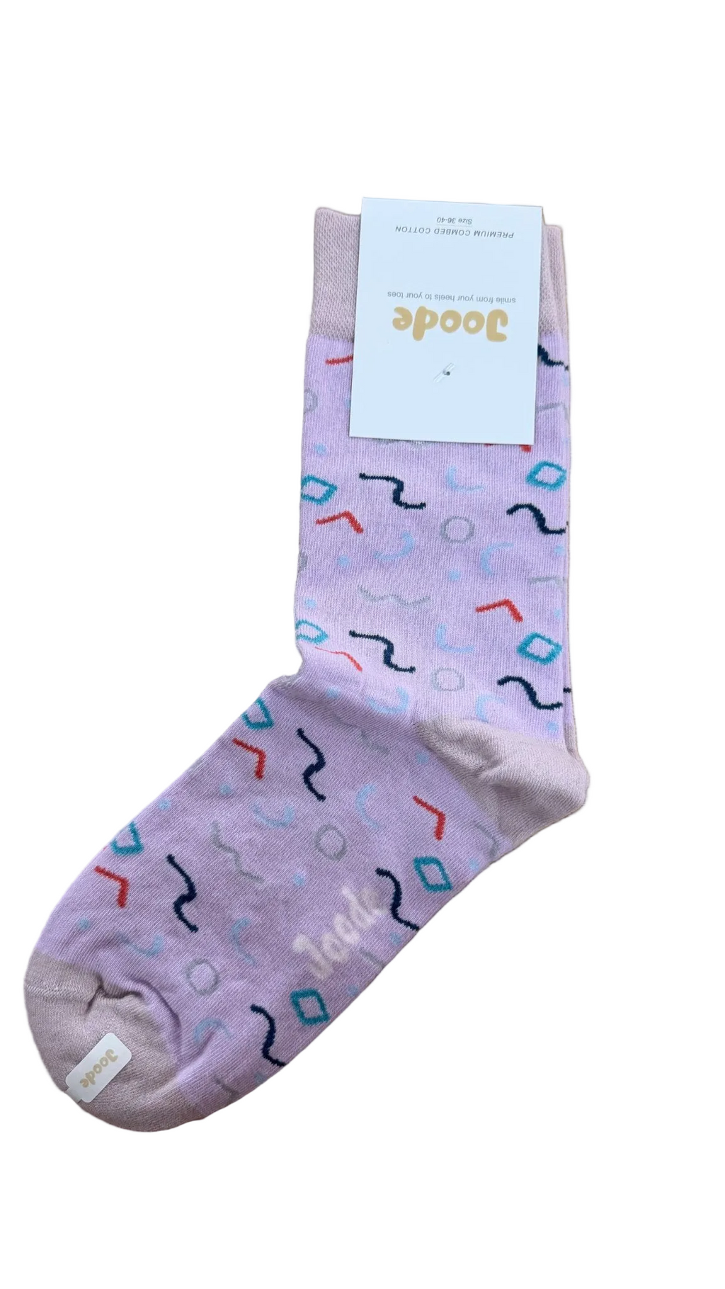 A single light purple crew sock with a colorful geometric pattern, featuring a white paper tag with the brand name 'Joode' on a wooden floor.