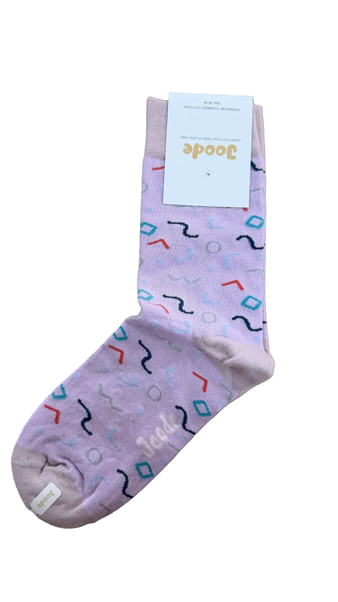 A single light purple crew sock with a colorful geometric pattern, featuring a white paper tag with the brand name 'Joode' on a wooden floor.