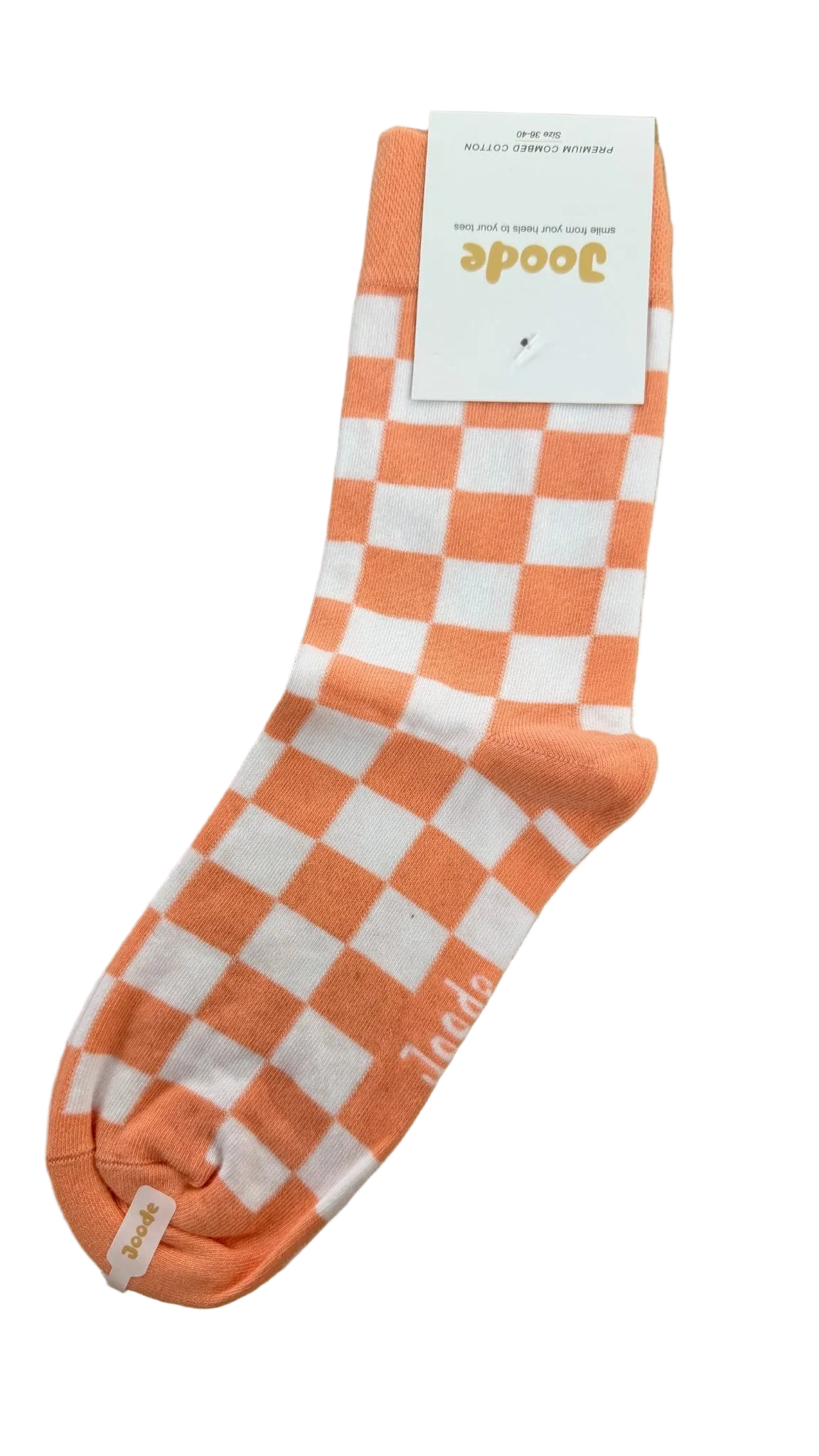 A single sock with a peach and white checkerboard pattern, featuring a white paper tag attached near the cuff. The brand name 'Joode' is visible on the tag.