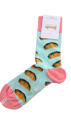 A single light blue sock with a repeating taco print and pink toe/heel/cuff, laid flat on a wooden surface with a white paper tag attached.