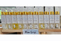 Row of white bottles with gold caps labeled 'Room Sprays' on a white background.