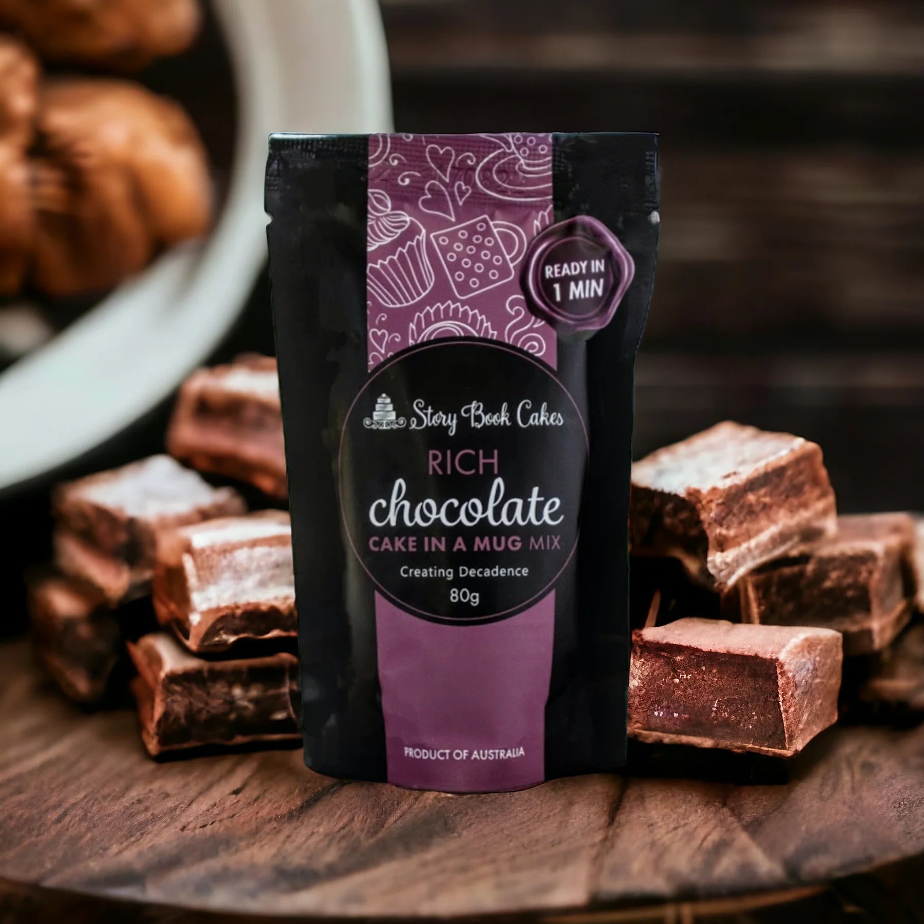 Packaged rich chocolate cake in a mug mix with cake pieces on a wooden surface