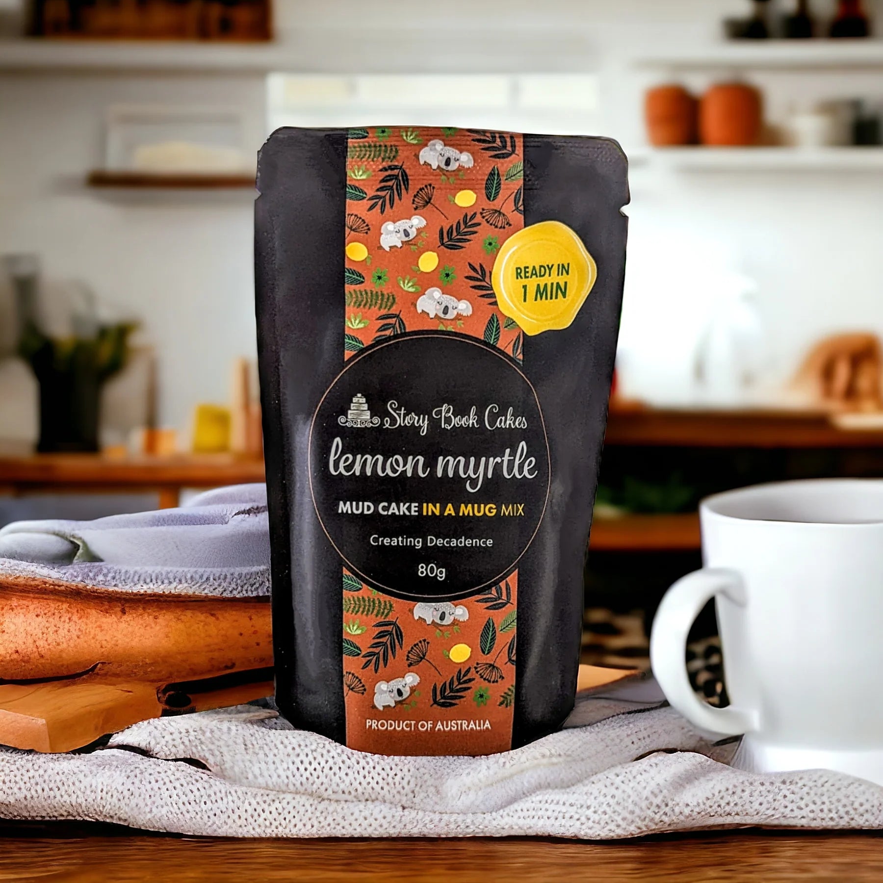 Packaged lemon myrtle mud cake mix with a mug on a kitchen counter