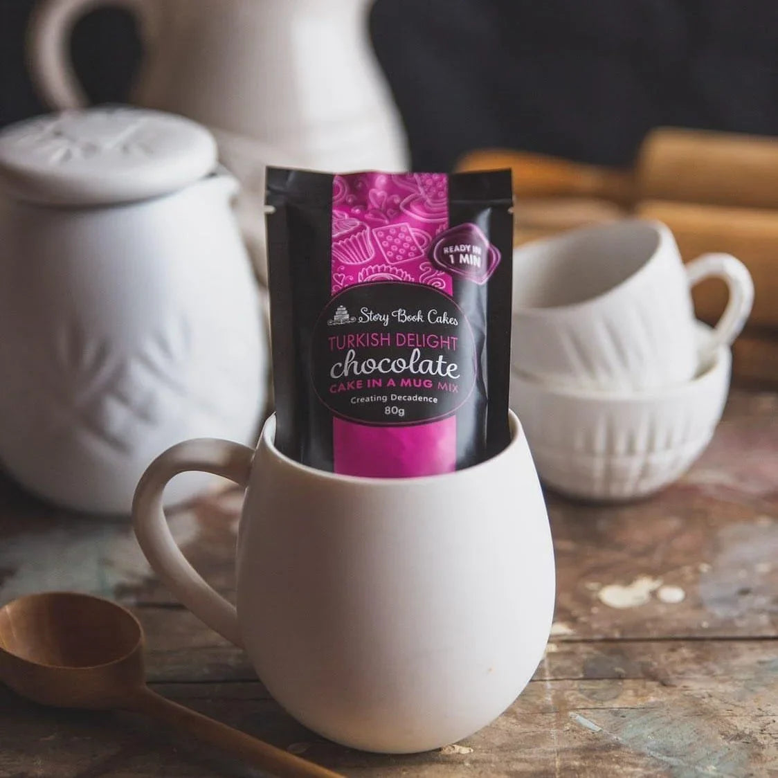 Turkish Delight chocolate package in a white mug with teapots and cups in the background