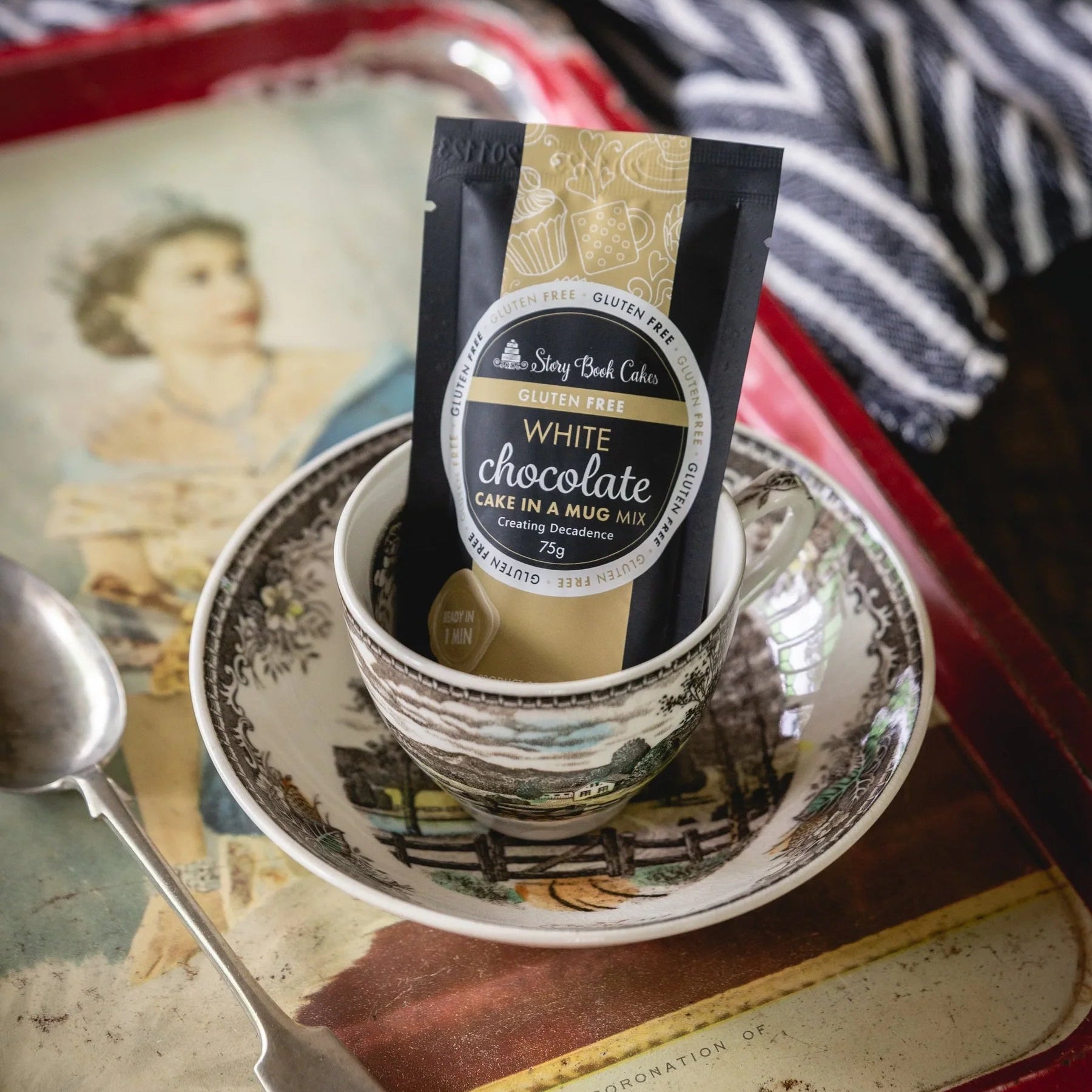 White chocolate cake mix package on a saucer with a spoon on a vintage tray
