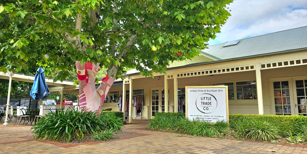 Building exterior with a sign for 'Little Trade Co. store in Federation Square, Nicholls ACT.