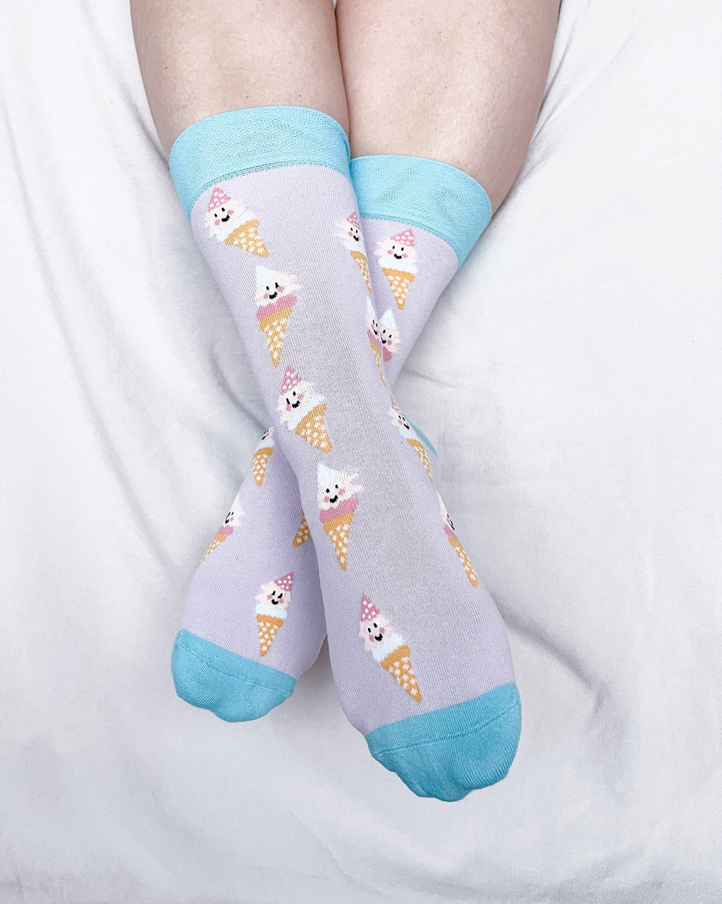 Socks with ice cream cone and penguin design on a light purple background
