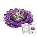 A sleeping baby dragonfly nestled inside a large purple flower, with two small product boxes shown in front on a plain white background.